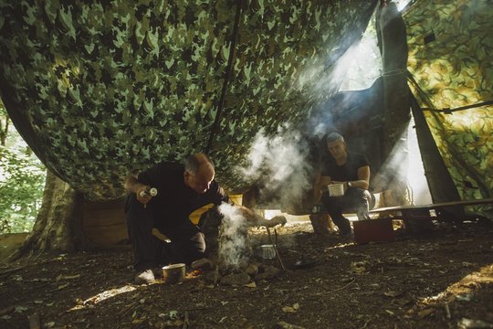 Two men preparing food at boot camp