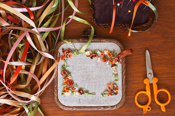 Embroidery with satin ribbons in golden brown tones on a square hoop (The embroidery was made by...