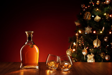 close up view  of two glasses with whiskey on color back. 