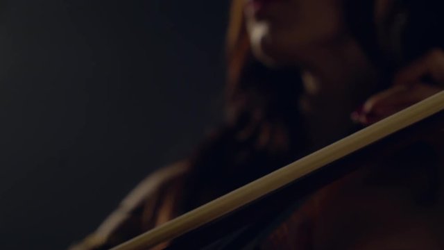 The cellist performs on stage.
