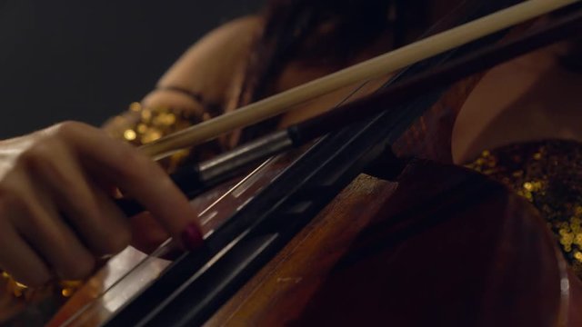The cellist performs on stage.