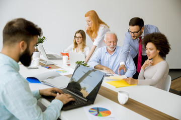 Joyful multiracial business team at work in modern office