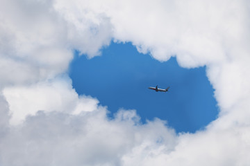 Fototapeta na wymiar Airplane in the sky with clouds and blue sky