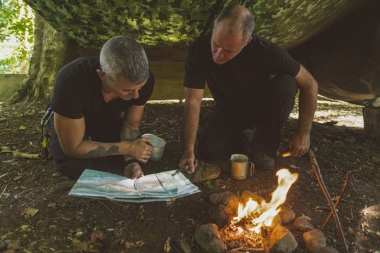 Two men looking at map in boot camp