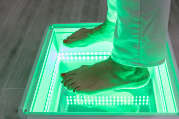 Orthopedics, foot podoscope test. Female feet during a podoscopic examination in an orthopedic surgery