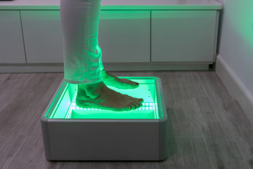 Orthopedics, foot podoscope test. Female feet during a podoscopic examination in an orthopedic surgery