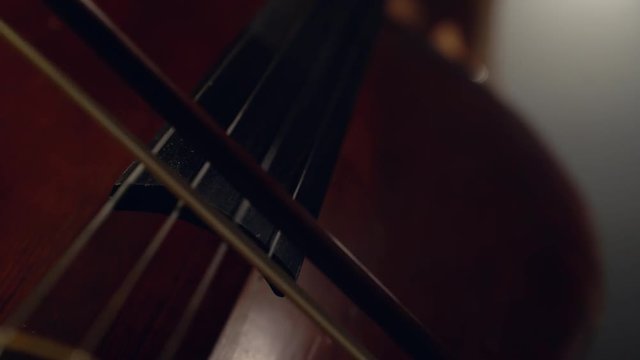 The cellist performs on stage.