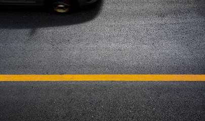 Yellow paint line on black asphalt. space transportation background
