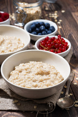 homemade oatmeal and berries, vertical