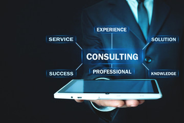 Man holding tablet with Consulting text. Business concept