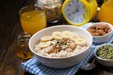 oatmeal with banana, honey and nuts for breakfast, top view