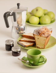 Breakfast - coffee and cupcake in a green bowl on a white background.