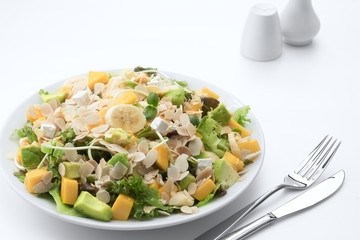 close up view of fresh vegetable salad on white background
