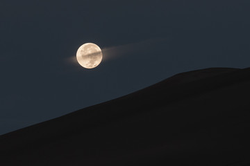 Full moon rises over great sand dunes national park