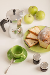 Breakfast - coffee and cupcake in a green bowl on a white background.