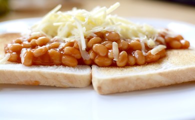 Baked beans on white toast with grated cheese 