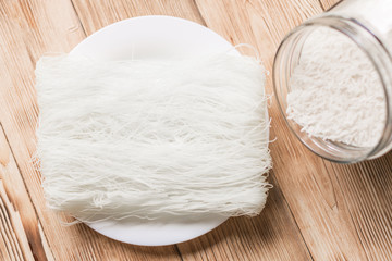 Dry rice, Chinese noodles, pasta on a wooden background.