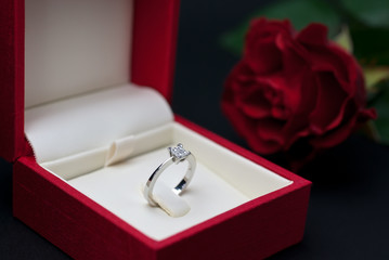 Modern diamond engagement ring in red jewellery box