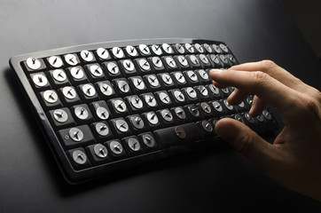 Hands above the keyboard with paper clips