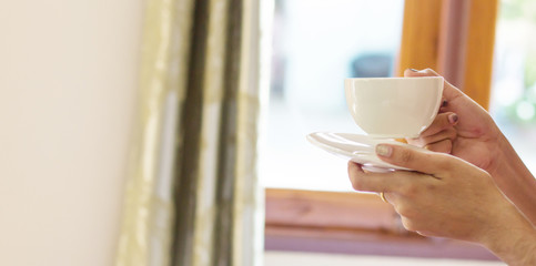 cup of coffee standing on bedroom has already rung early morning to wake up.
