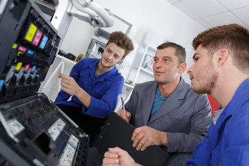 apprentices fixing photo copier