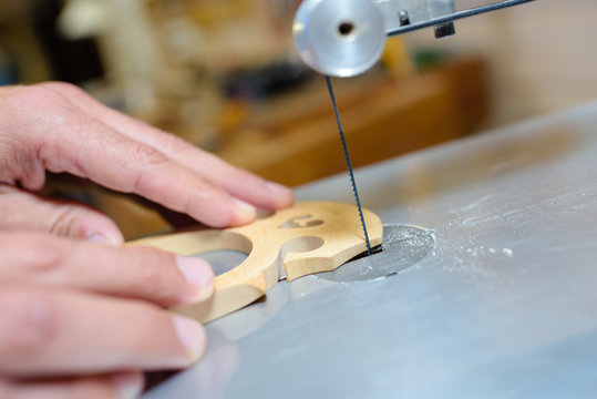worker sculpting precisely a piece of woo