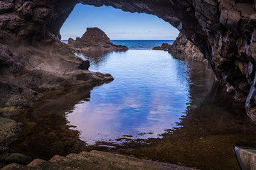 Seixal, Madeira/Portugal. Natural pool in front of the volcanic cliffs of Seixal on the Atlantic Ocean