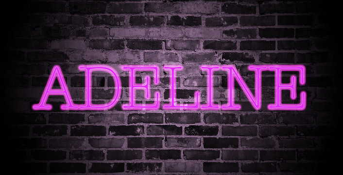 first name Adeline in pink neon on brick wall