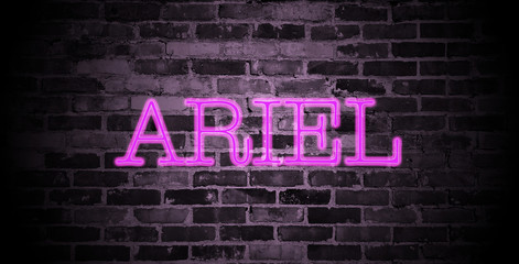 first name Ariel in pink neon on brick wall