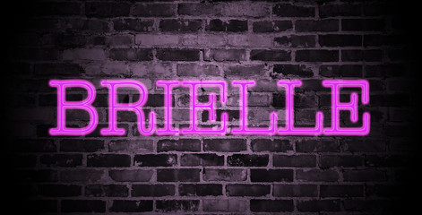 first name Brielle in pink neon on brick wall
