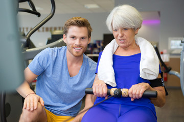 pretty woman using rowing machine