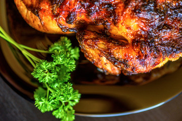 baked chicken on a dark wooden background.