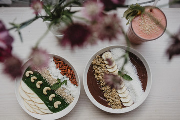 Artistically arranged bowls of yogurt with fruit and nuts
