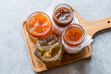 Various Jar of Fruit Jams Fig, Quince, Bergamot Citrus, Watermelon on Wooden Tray / Marmalade
