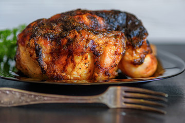 baked chicken on a dark wooden background.