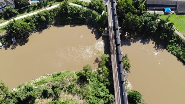 Aerial Drone Footage Of A Train Crossing A Trestle Over Buffalo Bayou In Houston