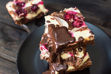 Chocolate cheesecake layered with brownie and dark cherrie. Chocolate cherrie cake. Pieces of chocolate cake. Winter dessert. Traditional american cuisine. Still life of food. Dark food photo.