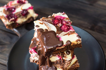 Chocolate cheesecake layered with brownie and dark cherrie. Chocolate cherrie cake. Pieces of...