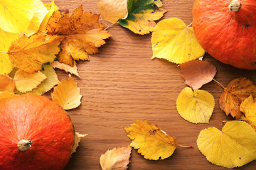 Autumn composition with yellow leaves and pumpkin