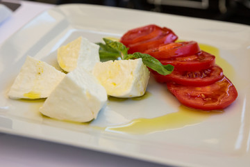 Buffalo mozzarella, tomato and basil salad dressed with extra virgin olive oil.