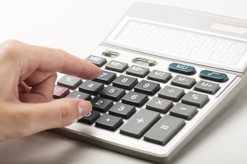 Close-up of a Woman Using Calculator