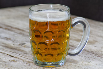 mug of beer on wooden table