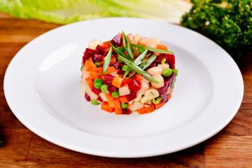 Vinaigrette. Traditional Russian cuisine. Salad with boiled beet root and vegetables on white plate. Close up