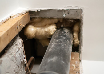 Preparation of repair the bathroom. Sewage pipe inside old soviet apartment.