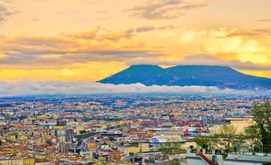 View of the city center of Naples and Mount Vesuvius along the Gulf of Naples at sunset in Naples,...