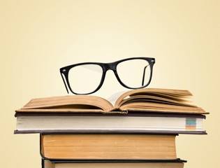 Black glasses on open books