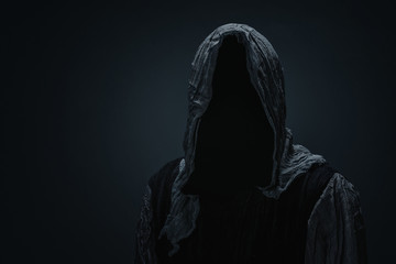 Silhouette of Grim Reaper over dark gray background with copy space - obrazy, fototapety, plakaty