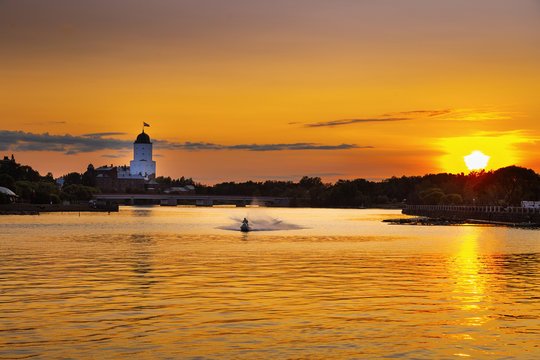 View of city of Vyborg at sunset, Vyborg Castle, Vyborg Bay, Leningrad Region, Russia. August 2018. Cityscape in rays of setting sun.