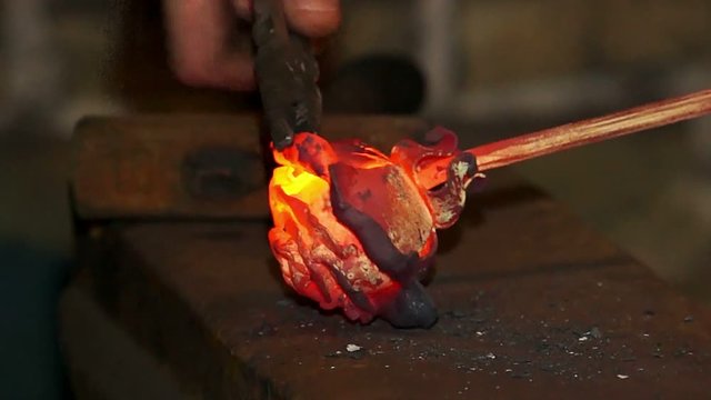 metal forging, Forging hot metal in smithy, Forge a rose made of metal, Ironsmith workpiece and forges it with a hammer,Forging iron rose on the flames coals, Forge a rose made of metal 