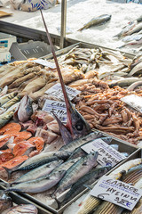 Naklejka premium Asprovalta, Greece - August 13, 2018: Selling fresh fish and squid on public market